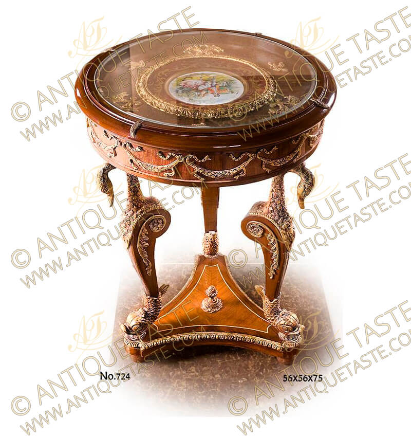 Napoleon Second Empire Style gilt-ormolu-mounted porcelain sevres top Display End Table / Salon bijouterie, The glass round top covers a fine Sevres porcelain plate plaque representing a royal court scene, available also in roses per request, the fine Sevres porcelain piece is encircled of an ormolu foliate hammered trim, surrounded with foliate leaves scattered around, The apron is decorated with gilt ormolu knotted ribbons all around above a fine chiseled gilt-ormolu and patinated swan neck top part cabriole legs, the second part of the turning legs is ornamented with baroque style foliate ormolu mounts centered with flower rosette, the legs terminates with ormolu dolphin sabots, symbolizing swiftness, charity and love, The legs are connected with a triangular stretcher with concave sides centered with an engraved ormolu pine cone and edged with a twisted hammered ormolu strips and rest on ball feet, The fine table is one of other two other styles of the same table as a center coffee table with extra porcelain sevres plates and another of a different size, completing a set per request, finest quality to be found only with Antique Taste Production